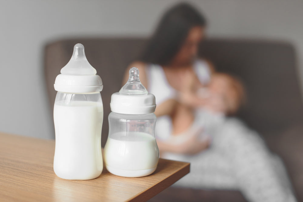 Baby bottles of expressed breast milk ready for the fridge